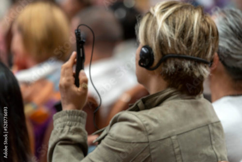 Blurry background, a set of headphones for simultaneous translation during negotiations in foreign languages. woman headphones used for simultaneous translation equipment simultaneous interpretation 