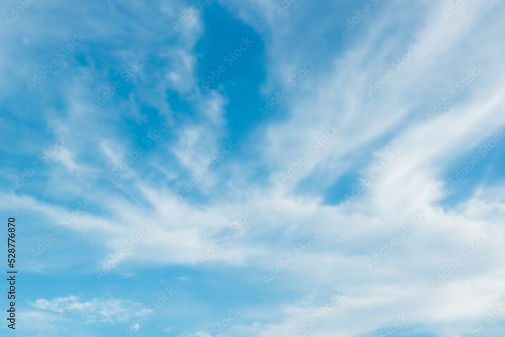 bright blue sky warm background with white clouds cumulus floating soft focus, copy space.