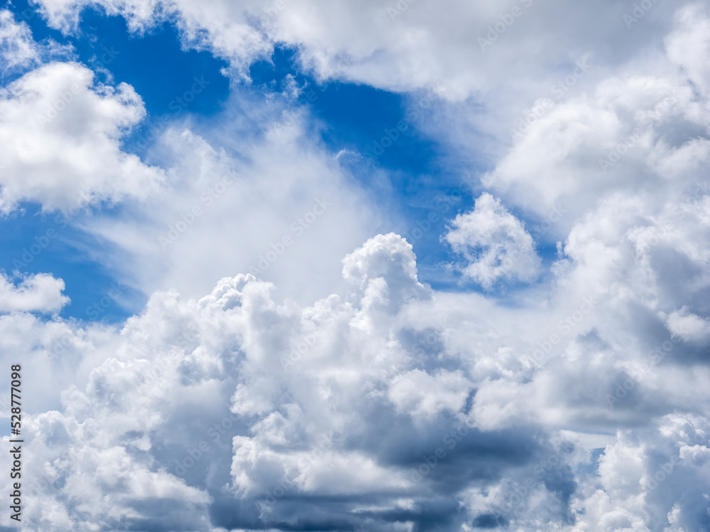 Overhead white dramatic clouds in a blue sky Overhead white dramatic clouds in a blue sky