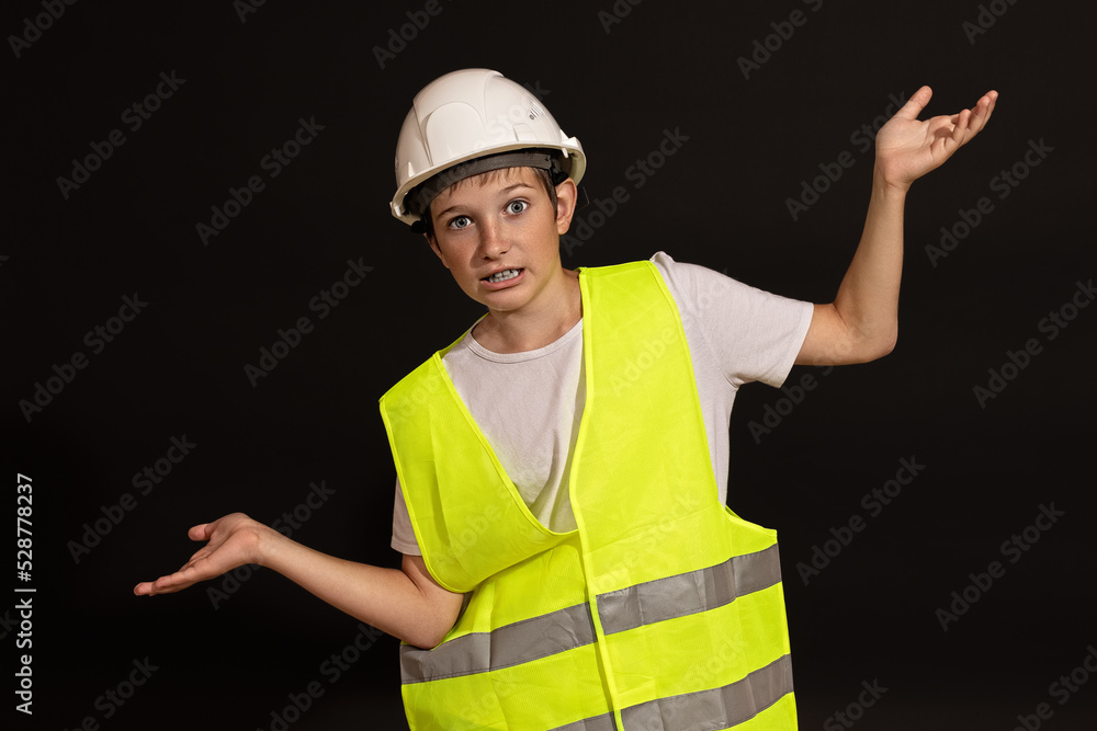 young builder shows a symbol of scales. mass concept. justice concept. young builder shows a symbol of scales. mass concept. justice concept.