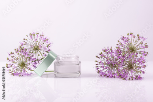 cosmetic cream with flowers on a white background. Face and hand skin care. Natural cosmetic