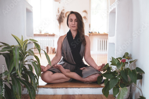 woman practicing yoga lesson, breathing, meditating, doing Padmasana exercise photo