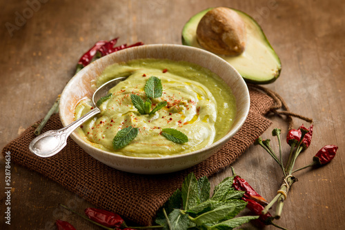 avocado soup with mint leaf and hot chili pepper