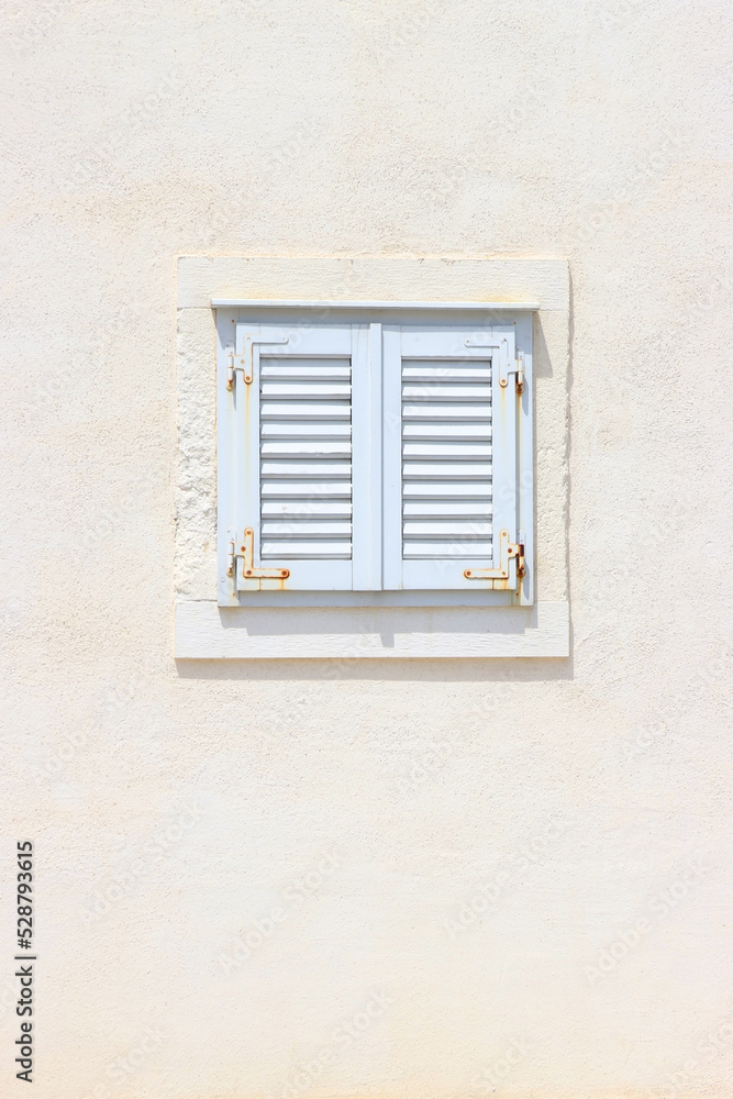 Traditional Mediterranean window in white on white background. 