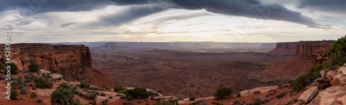 Scenic Panoramic View of American Landscape and Red Rock Mountains in Desert Canyon. Cloudy Sunset Sky. Canyonlands National Park. Utah  United States. Nature Background Panorama