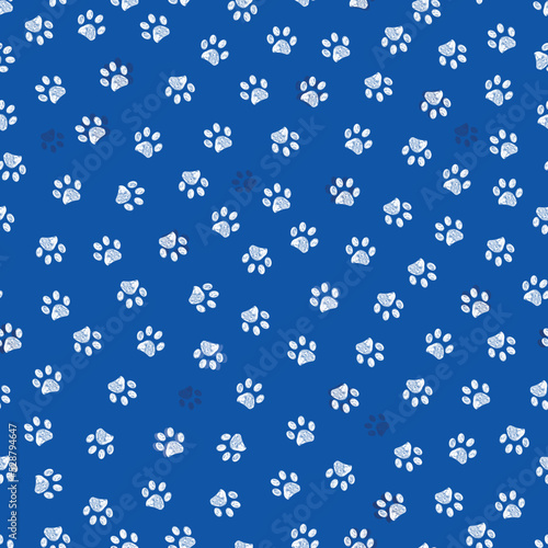 Blue background with white paw prints seamless fabric pattern