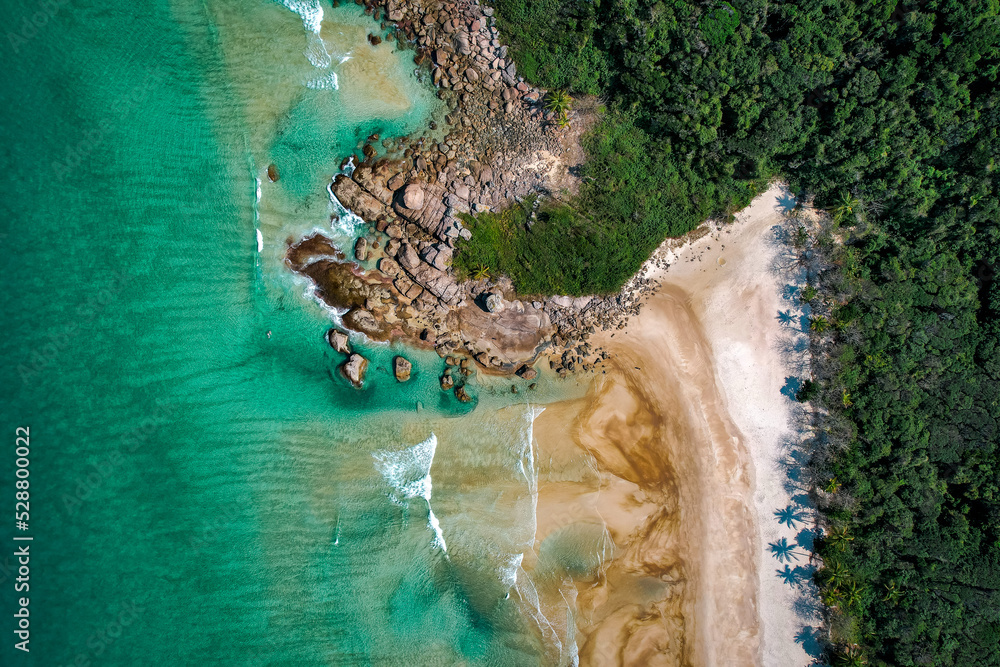Tropical island without people, with golden sand and tropical greenery, drone view