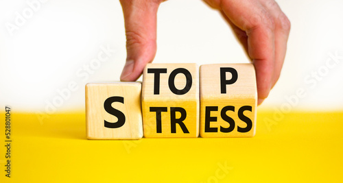 Stop stress and be health symbol. Doctor turns wooden cubes and changes concept words Stress to Stop. Beautiful yellow table white background. Psychological business stop stress concept. Copy space.