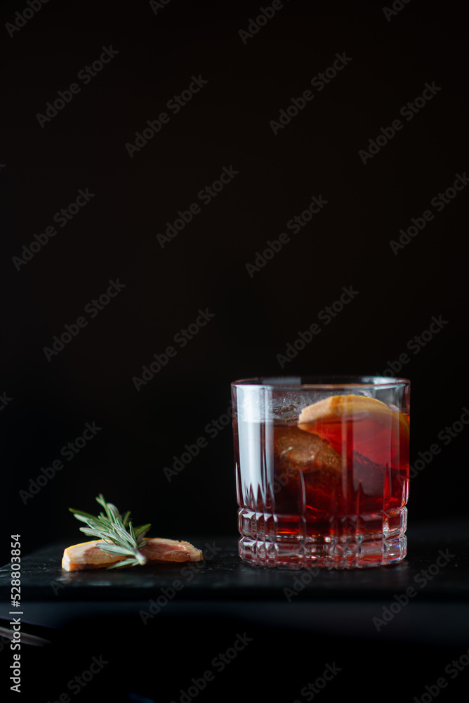 negroni with garnish on black background negroni with garnish on black background