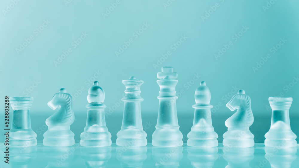 Chess game. Chess pieces made of glass. Rivalry concept. Selective focus included. Chess game. Chess pieces made of glass. Rivalry concept. Selective focus included.