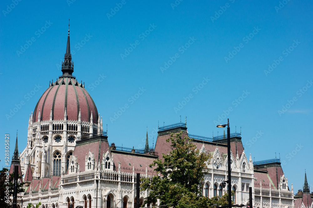 The red roof dome of the Parliament House in Budapest, Hungary, is only a small part of the massive government buildings with awesome spires, arches, towers, and railings.