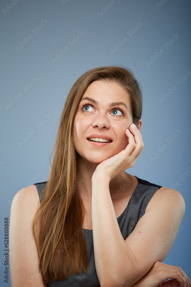 Business woman thinking and looking up touching her face. isolated on blue. Business woman thinking and looking up touching her face. isolated on blue.