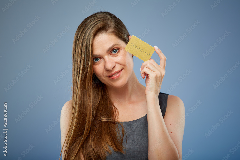 Woman smilng and holding gold credit card. isolated portrait. Woman smilng and holding gold credit card. isolated portrait.