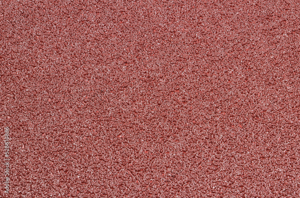 Fototapeta premium Background - red sandpaper with a clearly visible structure.