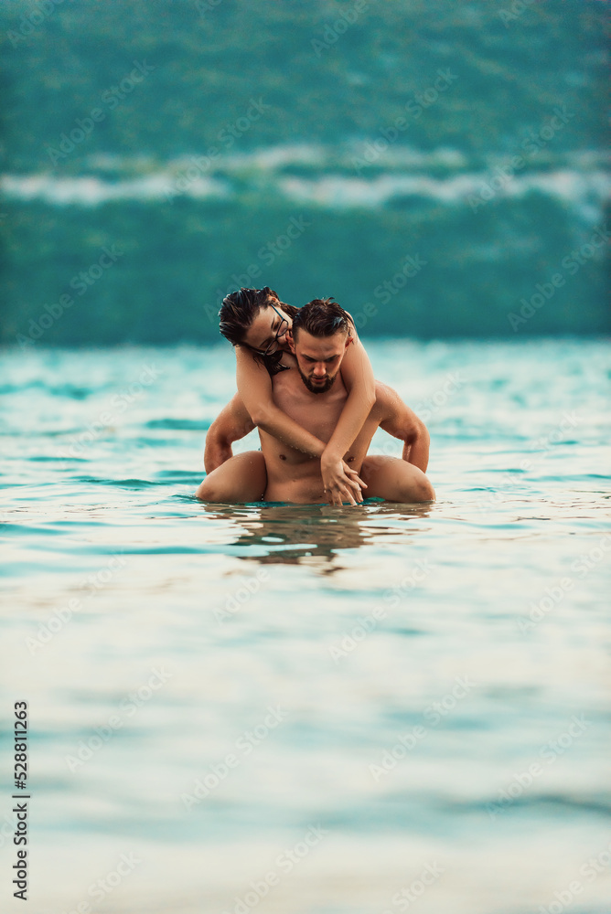 A sexy couple comes out of the sea after swimming. High quality photo