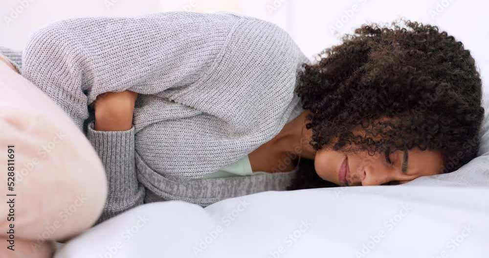 Bed, stomach pain and young woman doing massage on tummy for menstruation ache relief problem. Sad, sick and frustrated girl feeling stress from abdomen cramps while lying down in bedroom. Bed, stomach pain and young woman doing massage on tummy for menstruation ache relief problem. Sad, sick and frustrated girl feeling stress from abdomen cramps while lying down in bedroom.