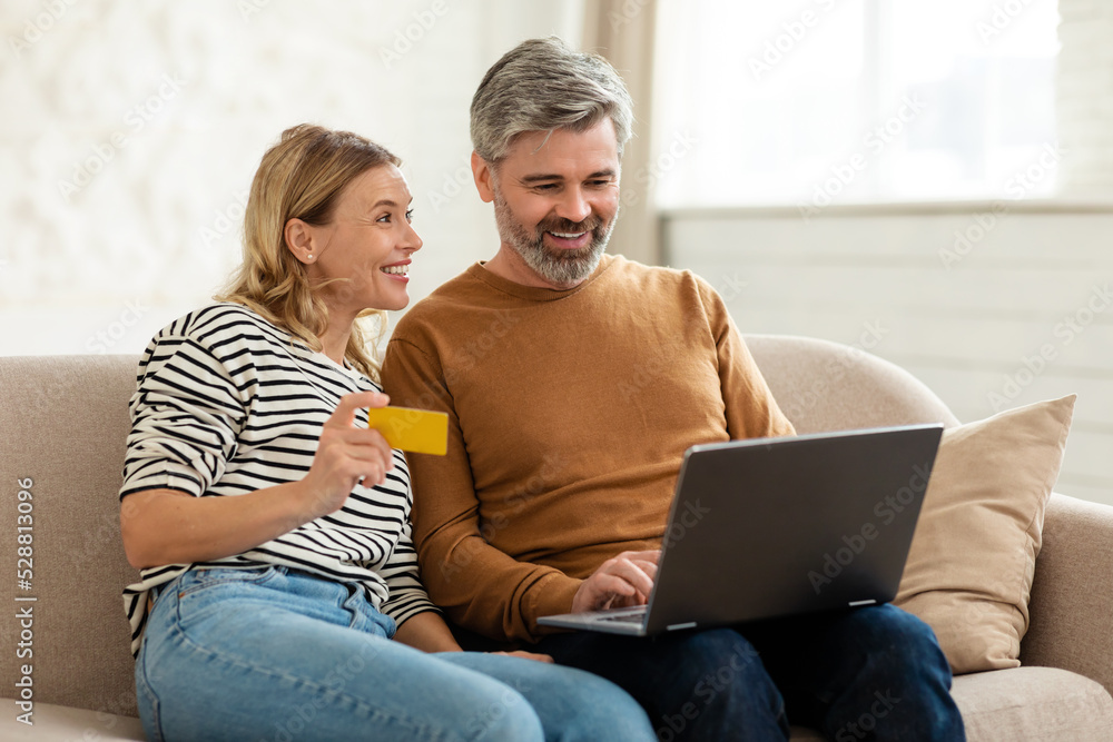 Couple Making Payment Using Laptop And Credit Card Shopping Indoor Couple Making Payment Using Laptop And Credit Card Shopping Indoor