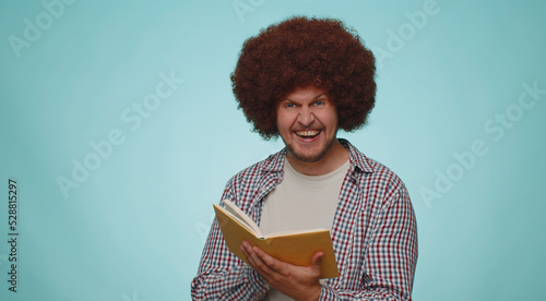 Принти на полотні Happy smiling bearded man reading funny interesting fairytale story book, leisure hobby, knowledge wisdom, education, learning, study, wow