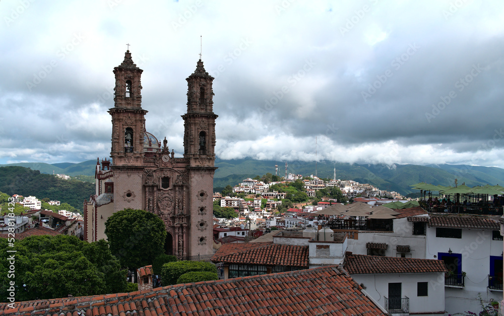 Santa Prisca Temple in Taxco Mexico with some buildings around