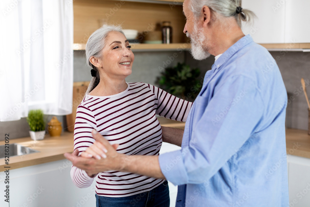 Portrait Of Loving Senior Couple Dancing Together In Kitchen Interior, Portrait Of Loving Senior Couple Dancing Together In Kitchen Interior,