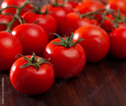 Many ripe tomatoes on wooden surface. High quality photo © JackF