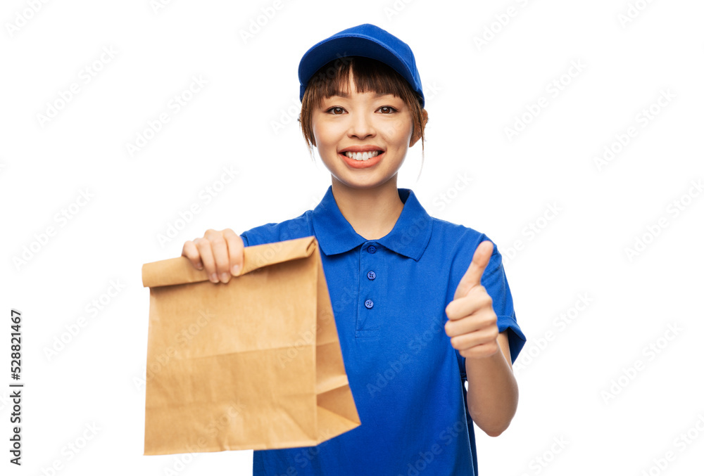 service and job concept - happy smiling delivery woman in blue uniform with takeaway food in paper bag showing thumbs up gesture over white background service and job concept - happy smiling delivery woman in blue uniform with takeaway food in paper bag showing thumbs up gesture over white background