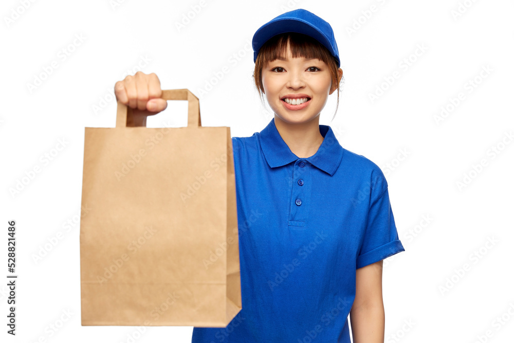 service and job concept - happy smiling delivery woman in blue uniform with takeaway food in paper bag over white background service and job concept - happy smiling delivery woman in blue uniform with takeaway food in paper bag over white background