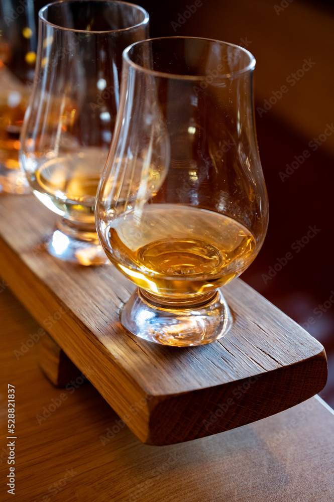Flight of single malt scotch whisky in glasses served in whiskey bar in Edinburgh, UK Flight of single malt scotch whisky in glasses served in whiskey bar in Edinburgh, UK