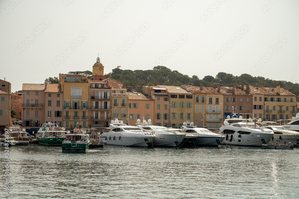Colorful houses and yachts in Port of Saint Tropez, village on Mediterranean sea with yacht harbour, Provence, France