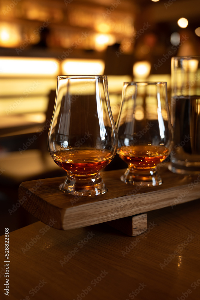 Flight of single malt scotch whisky in glasses served in whiskey bar in Edinburgh, UK Flight of single malt scotch whisky in glasses served in whiskey bar in Edinburgh, UK