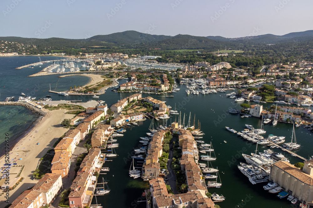 Aerial view on Gulf of Saint-Tropez, sail boats, houses of Port Grimaud and Port Cogolin, summer vacation in Provence, France