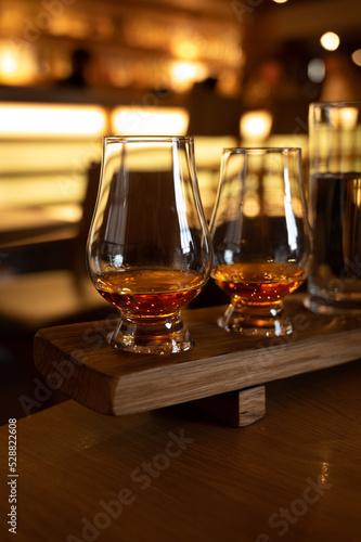 Flight of single malt scotch whisky in glasses served in whiskey bar in Edinburgh, UK