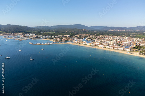 Aerial view on Gulf of Saint-Tropez, sail boats, houses of Port Grimaud and Port Cogolin, summer vacation in Provence, France
