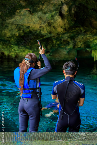 Some people is snorkeling on a cenote in Cancun Mexico