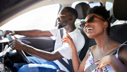 Freedom, travel and couple on a car road trip happy, singing music and driving. Black woman and man from Kenya relax traveling on a summer vacation or holiday on mobile transportation with a smile