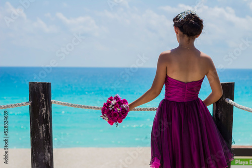 Graduated girl is on the photo session on the caribbean sea. Cancun Mexico