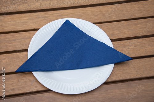 blue napkin on a white cardboard plate