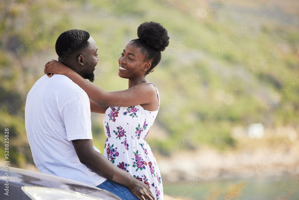 African couple with smile on road trip with car, travel on summer vacation and happy on drive with transport. Happiness, smile and love man and woman giving hug at the sea during a date in spring African couple with smile on road trip with car, travel on summer vacation and happy on drive with transport. Happiness, smile and love man and woman giving hug at the sea during a date in spring