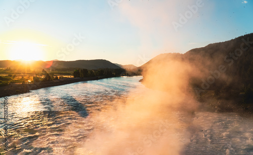 misty sunrise over the river through canyon
