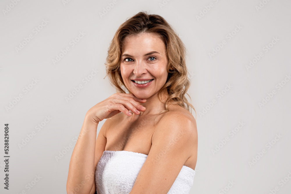 Portrait Of Happy Smiling Attractive Middle Aged Woman Wrapped In Bath Towel Portrait Of Happy Smiling Attractive Middle Aged Woman Wrapped In Bath Towel