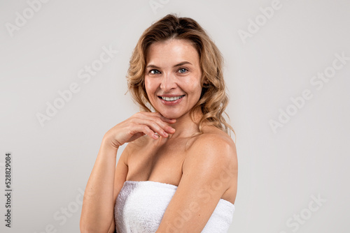Portrait Of Happy Smiling Attractive Middle Aged Woman Wrapped In Bath Towel