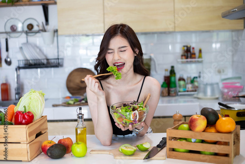 Beautiful Asian Woman smiling preparing vegetable salad in the kitchen Healthy FoodsVegan SaladsVegetarian SaladFood IdeasDiet IdeasHealthy LifestyleCooking At Home photo