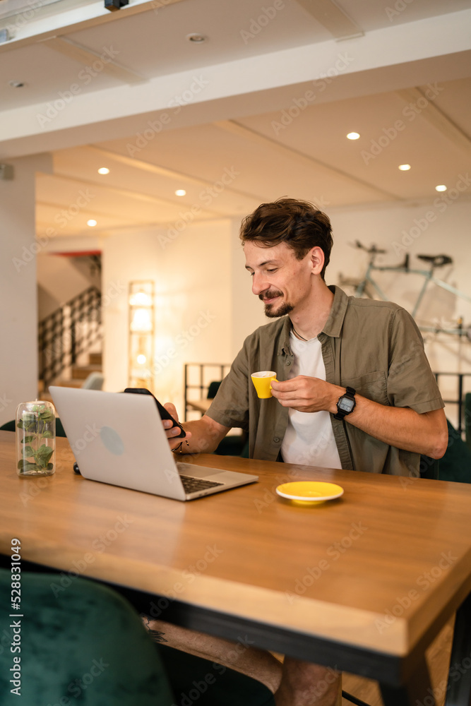 One modern caucasian man using mobile phone while stand at cafe One modern caucasian man using mobile phone while stand at cafe