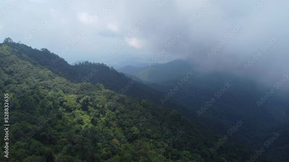 Aerial view of a hilltop road with beautiful green forests in Thailand. Landscape of nature background in motion. Travel and transportation concept Aerial view of a hilltop road with beautiful green forests in Thailand. Landscape of nature background in motion. Travel and transportation concept