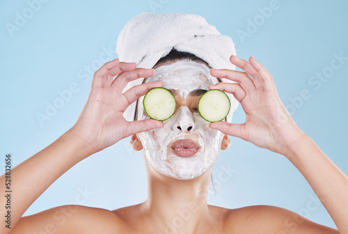 Skincare, beauty and face mask with cucumber slice on a beautiful woman taking care of her clean, healthy and natural skin. Fresh, wellness and relax during routine pamper spa cosmetology treatment