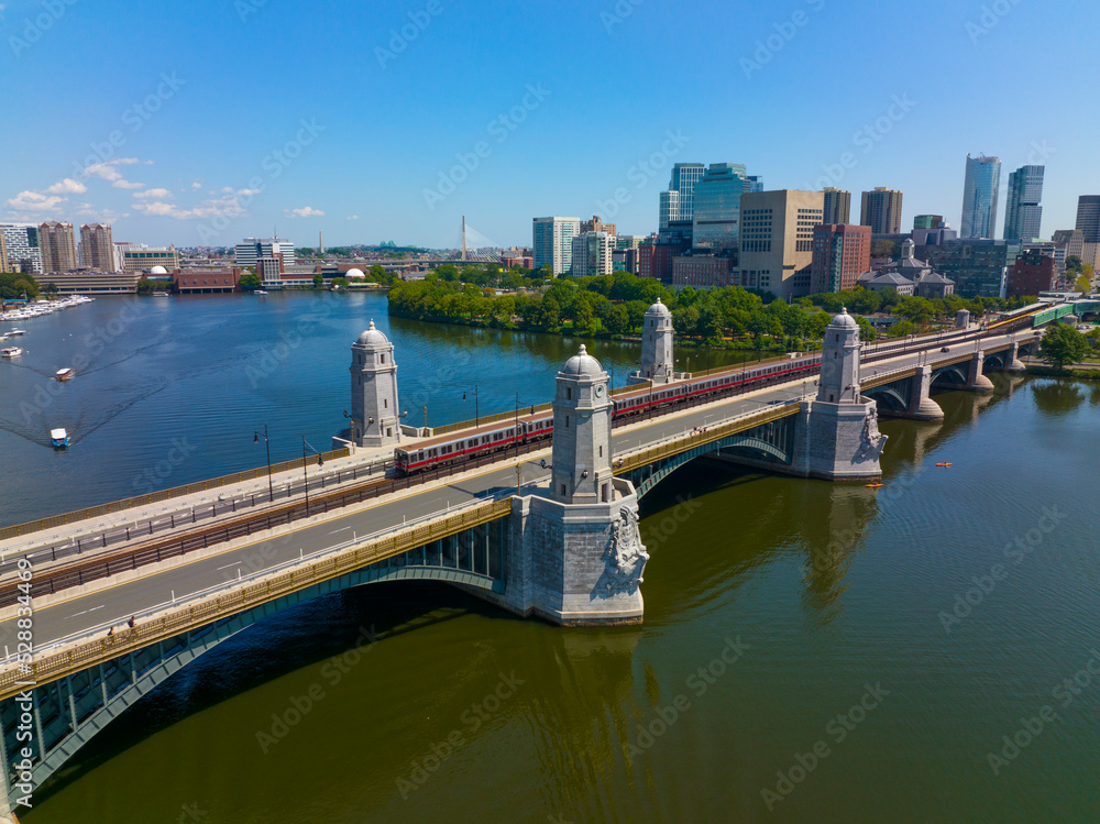 MBTA red line on Longfellow Bridge cross over Charles River, with Boston financial district modern city skyline at the back, in downtown Boston, Massachusetts MA, USA. 