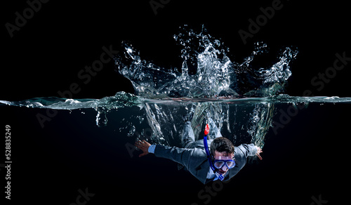 Funny businessman swimming underwater . Mixed media