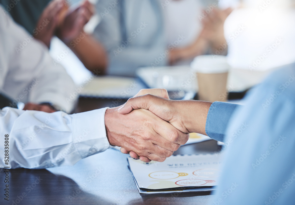 Businessman shaking hands with his partner to make a corporate deal at meeting in the office. Closeup of professional employees greeting with handshake at company conference, tradeshow or convention. Businessman shaking hands with his partner to make a corporate deal at meeting in the office. Closeup of professional employees greeting with handshake at company conference, tradeshow or convention.