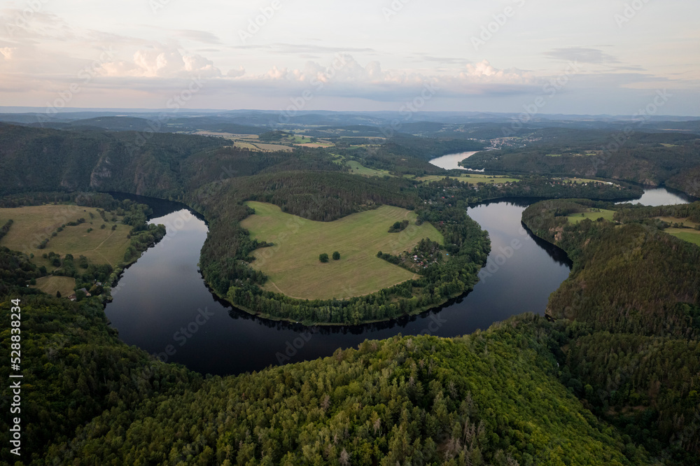 Early morning view of Vltava river canyon horseshoe shape meander across river opposite to Solenice viewpoint. From bird view in river band Czech Republic.