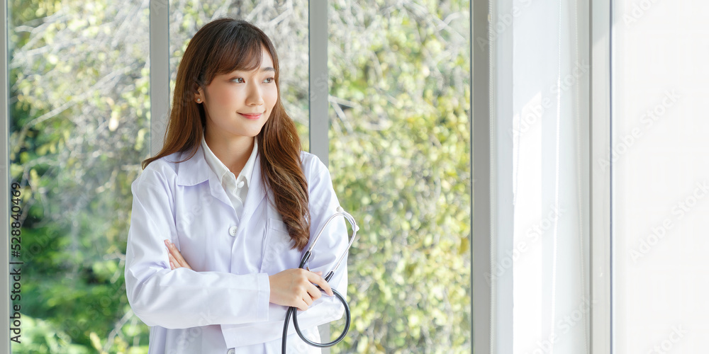 Beautiful and cheerful good mood young lady asian doctor dressed uniform smiling arm stethoscope on lobby hospital background. COPY SPACE. Beautiful and cheerful good mood young lady asian doctor dressed uniform smiling arm stethoscope on lobby hospital background. COPY SPACE.